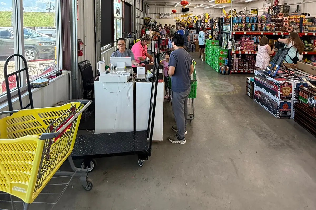 The main aisle with shopping carts and the checkout counter by the windows